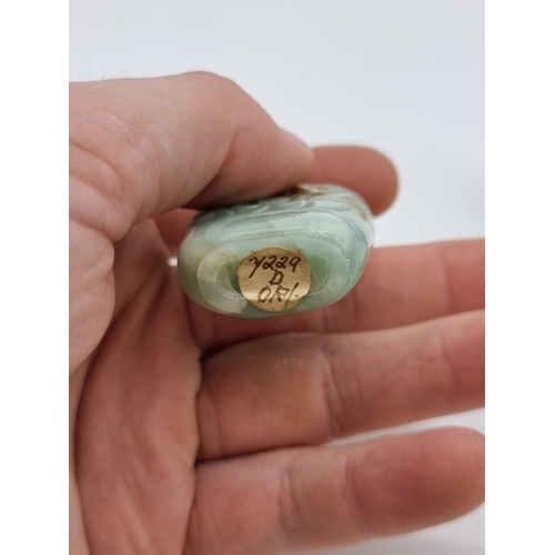 1372 - Two Chinese carved jade snuff bottles and stoppers, Qing, total height of largest 7cm. (2)... 