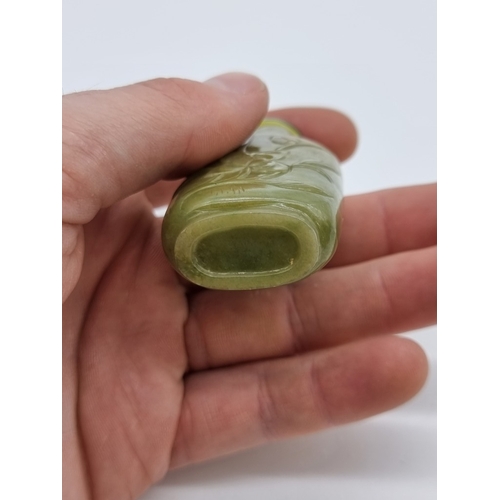 1372 - Two Chinese carved jade snuff bottles and stoppers, Qing, total height of largest 7cm. (2)... 