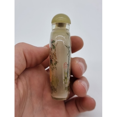 1373 - A Chinese internally painted glass 'cat and panda' snuff bottle, signed, with jade cover, total heig... 
