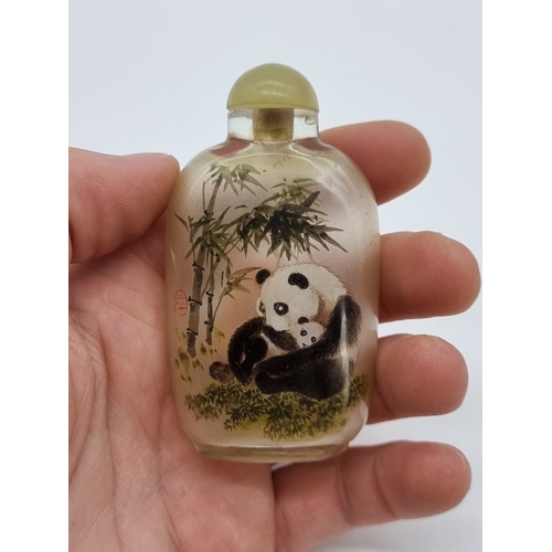 1373 - A Chinese internally painted glass 'cat and panda' snuff bottle, signed, with jade cover, total heig... 