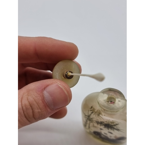 1373 - A Chinese internally painted glass 'cat and panda' snuff bottle, signed, with jade cover, total heig... 