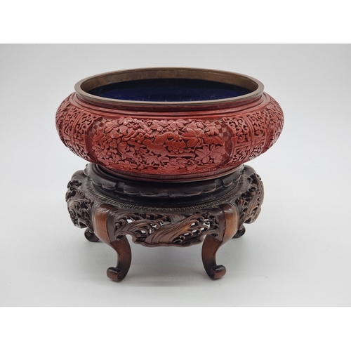 1392 - An unusual Chinese cinnabar lacquer and cloisonne enamel bowl, 24.5cm diameter, on good carved and p... 
