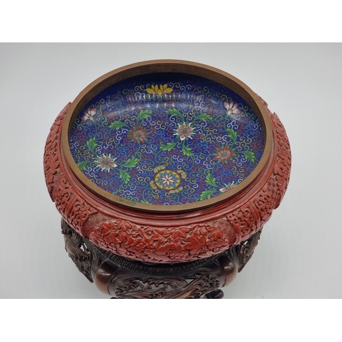 1392 - An unusual Chinese cinnabar lacquer and cloisonne enamel bowl, 24.5cm diameter, on good carved and p... 