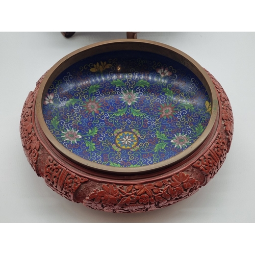 1392 - An unusual Chinese cinnabar lacquer and cloisonne enamel bowl, 24.5cm diameter, on good carved and p... 