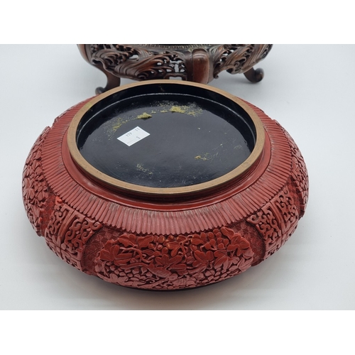 1392 - An unusual Chinese cinnabar lacquer and cloisonne enamel bowl, 24.5cm diameter, on good carved and p... 