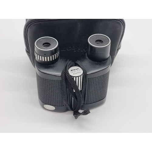 1395 - A pair of Nikon 7x21 binoculars, in leather case.