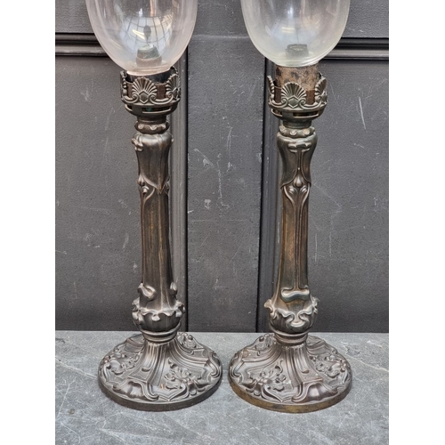 1412 - A pair of Art Nouveau style bronze storm lamps, total height 65cm, (crack to one glass shade).... 
