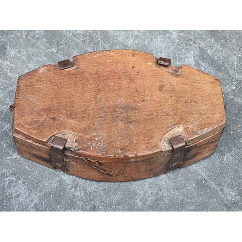 1416 - A vintage treen butter mould, 21.5cm wide; together with a spindle whorl, 7cm high. (2)... 