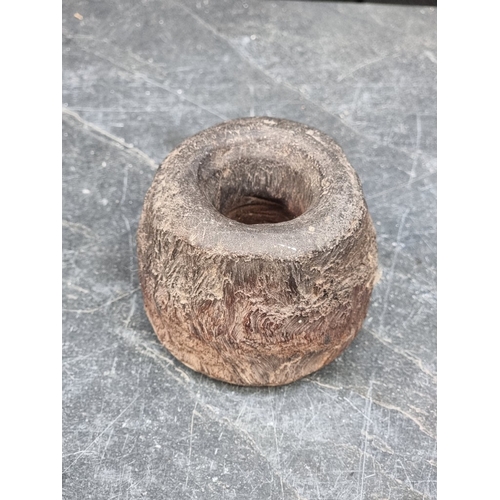 1416 - A vintage treen butter mould, 21.5cm wide; together with a spindle whorl, 7cm high. (2)... 