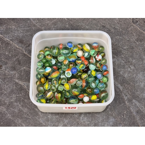1420 - A collection of old glass marbles.