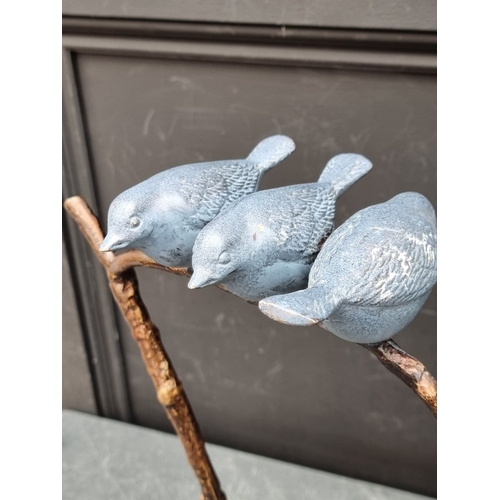 1438 - A patinated bronze sculpture of three birds on a branch, 39cm high.