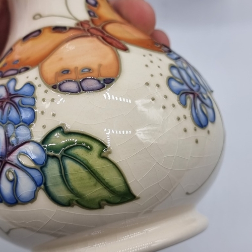 1445 - A Moorcroft 'Butterfly' pattern baluster vase, by Sally Tuffin, 16cm high, boxed, (crazed).... 