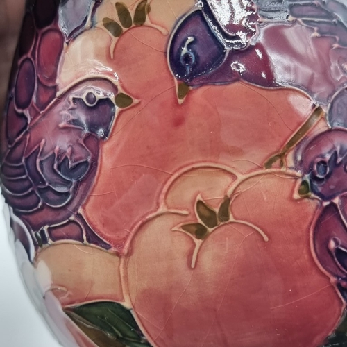 1462 - A Moorcroft 'Finches' pattern vase, 19cm high, (minor crazing), boxed.
