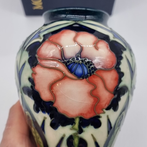 1463 - A Moorcroft 'Poppy' pattern inverted baluster vase, 16cm high, (minor crazing), boxed.... 