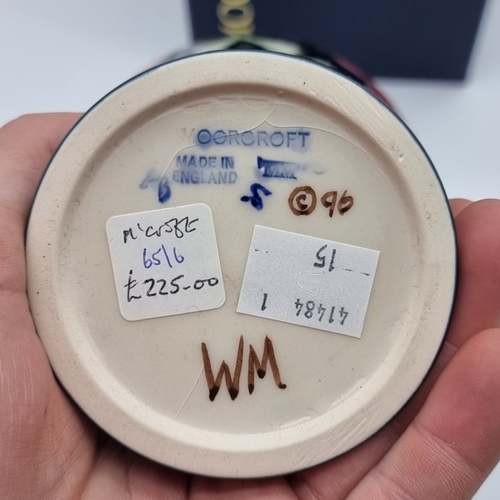 1463 - A Moorcroft 'Poppy' pattern inverted baluster vase, 16cm high, (minor crazing), boxed.... 