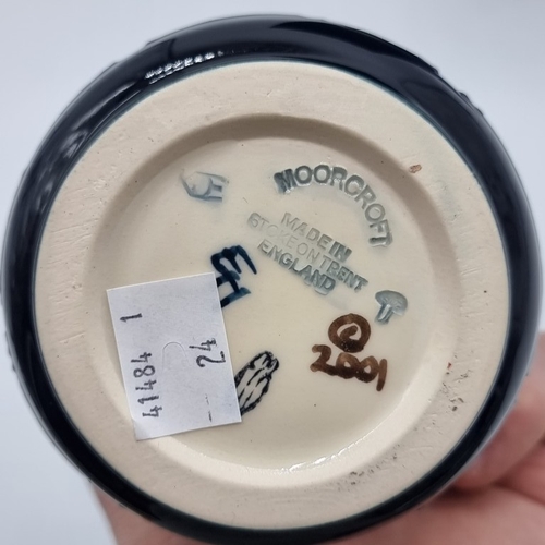 1473 - A Moorcroft 'Cala Lilly' pattern ewer, by Emma Bossons, 24cm high, boxed.