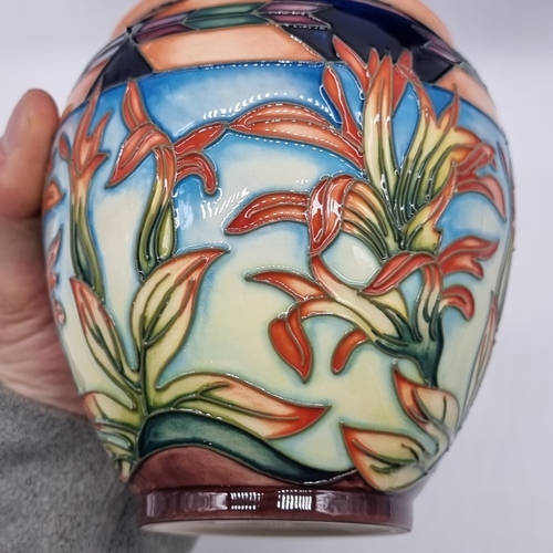 1478 - A Moorcroft 'Indian Paintbrush' pattern jar and cover, 14.5cm high, boxed.