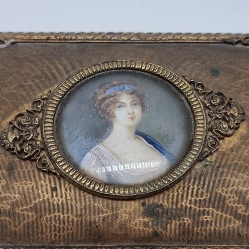 1525 - A late 19th century brass casket, the hinged top inset with a portrait miniature, on ivory, 4.7cm di... 
