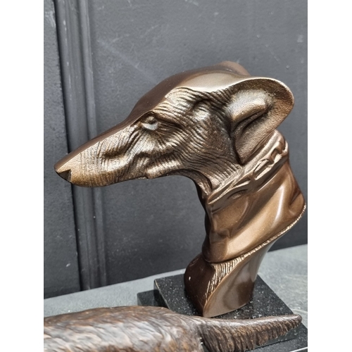1531 - A pair of bronze Borzoi, 26cm long; together with another bronze dogs head, 22cm high; together with... 