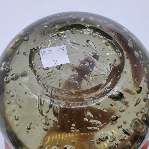 1538 - A large glass paperweight, 13.5cm high.
