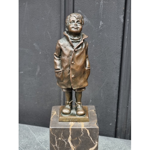 1565 - A bronze figure of a young boy, inscribed 'ManGreB', on marble socle, 28.5cm high.