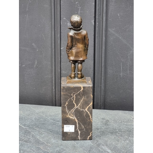 1565 - A bronze figure of a young boy, inscribed 'ManGreB', on marble socle, 28.5cm high.