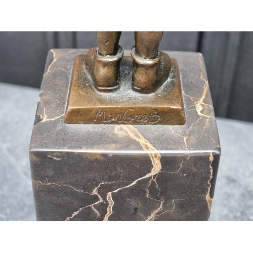 1565 - A bronze figure of a young boy, inscribed 'ManGreB', on marble socle, 28.5cm high.