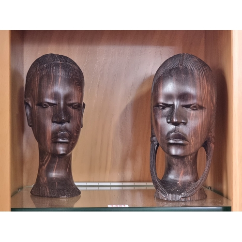 1431 - Ethnographica: a collection of carved ebony busts and similar, largest 25cm high. (5)... 