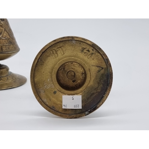 1432 - A pair of Aesthetic brass ewer form candlesticks, the bases moulded 'BT 836', 30.5cm high.... 