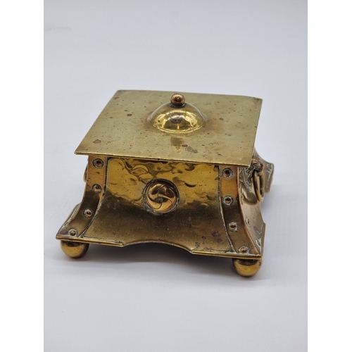 1433 - An Arts & Crafts hammered brass desk stand, 13cm wide; together with another glass and electropl... 