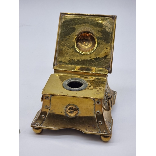 1433 - An Arts & Crafts hammered brass desk stand, 13cm wide; together with another glass and electropl... 