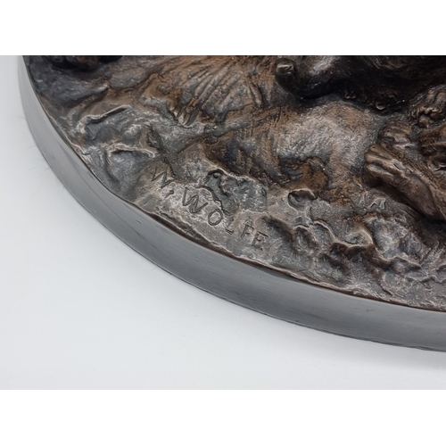 1437 - After W Wolfe, a bronzed figure group of a dog and two puppies, 35cm wide.