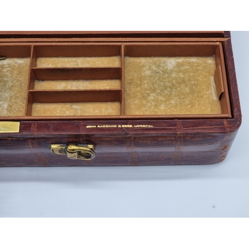 1440 - A crocodile jewellery case, inscribed 'John Bagshaw & Sons, Liverpool', 39cm wide.... 