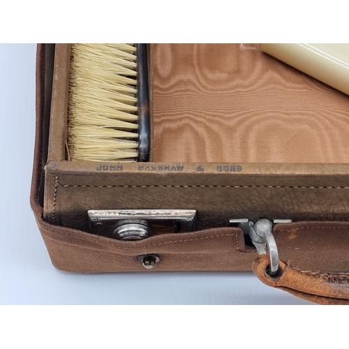 1441 - A leather vanity case, inscribed 'John Bagshaw & Sons, Liverpool', with partial tortoiseshell fi... 