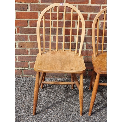 1075 - A rare pair of 1940s Ercol Windsor chairs, one labelled 'B.O.T., Price-Control Mark, Max. Price £2:7... 