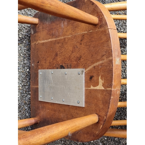 1075 - A rare pair of 1940s Ercol Windsor chairs, one labelled 'B.O.T., Price-Control Mark, Max. Price £2:7... 