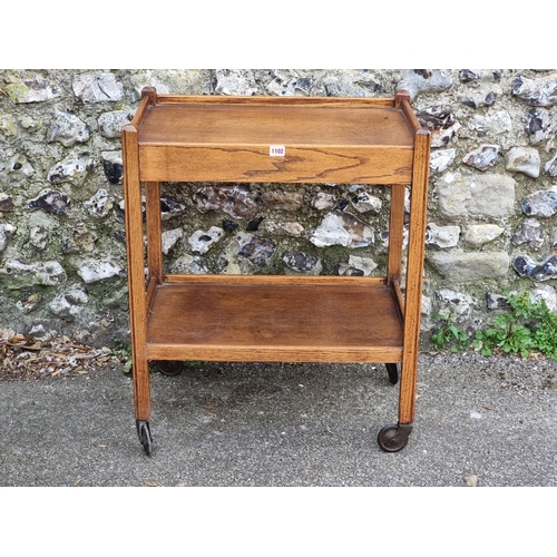 1102 - A 1920s oak tea trolley, with detachable tray to frieze, 64cm wide.