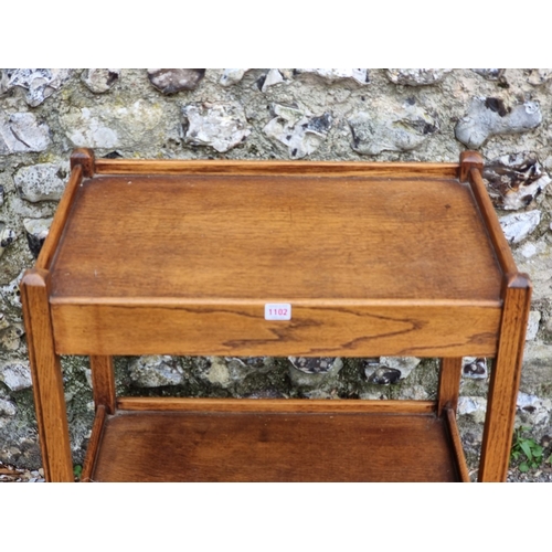 1102 - A 1920s oak tea trolley, with detachable tray to frieze, 64cm wide.