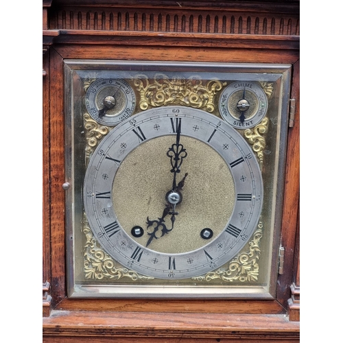 1184 - A late 19th century carved oak mantel clock, 44cm high, with pendulum.