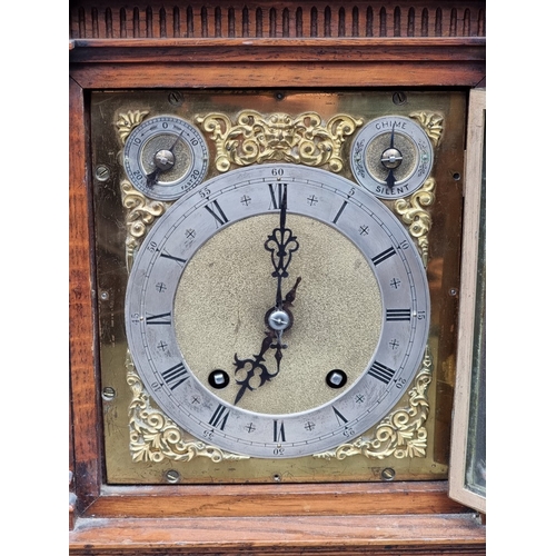1184 - A late 19th century carved oak mantel clock, 44cm high, with pendulum.