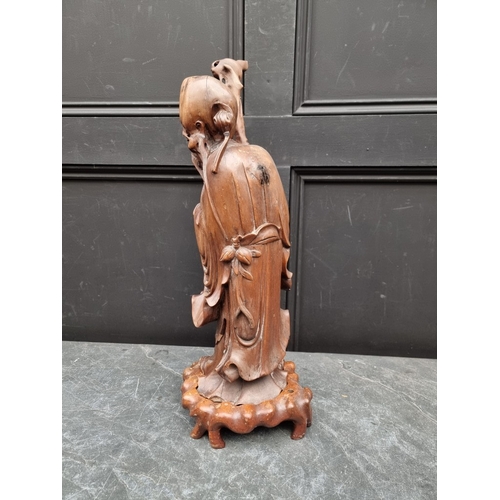 1414 - A large Chinese carved wood figure of Shoulao, on shaped and fitted stand, 58cm high, (minor damage)... 