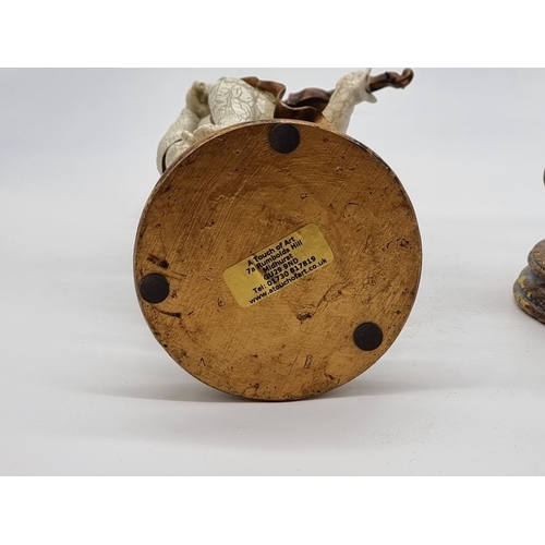 1560 - A pair of composition putti, 30cm high.