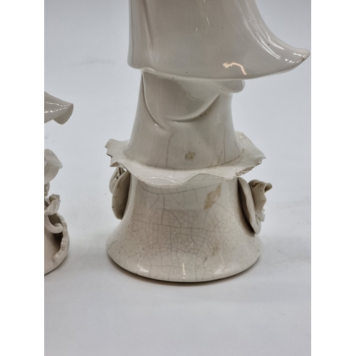 1571 - Three Chinese blanc de chine figures of Guanyin, largest 40.5cm high, (s.d. to each).... 