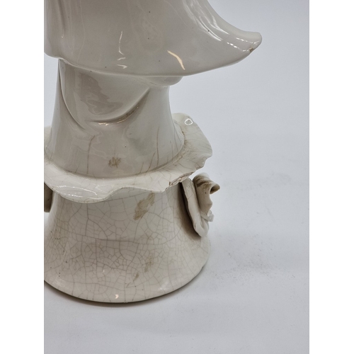 1571 - Three Chinese blanc de chine figures of Guanyin, largest 40.5cm high, (s.d. to each).... 