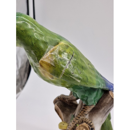 1575 - Three similar Continental porcelain Parrots, largest 30cm high, (s.d. to largest and smallest).... 