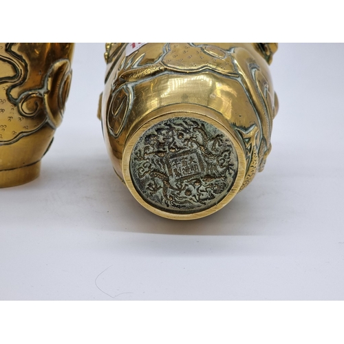 1580 - A pair of Chinese polished bronze dragon vases, Xuande six character seal mark to base, 22cm high.... 