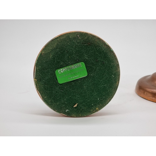 1582 - A pair of copper and brass ejector candlesticks, by Laurence Butler, labelled, 19.5cm high.... 