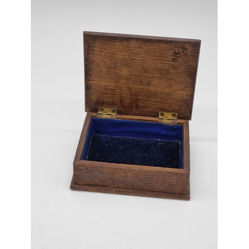 1585 - An Arts & Crafts style oak, copper and enamel casket, 11.5cm wide; together with a copper and br... 