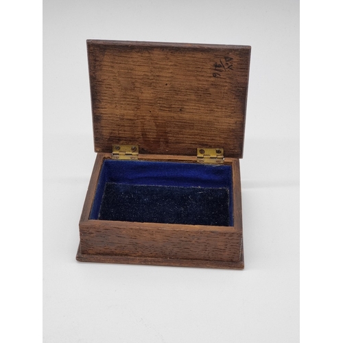 1585 - An Arts & Crafts style oak, copper and enamel casket, 11.5cm wide; together with a copper and br... 