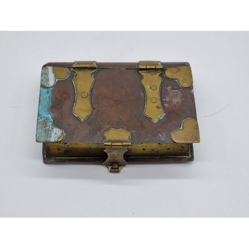 1585 - An Arts & Crafts style oak, copper and enamel casket, 11.5cm wide; together with a copper and br... 